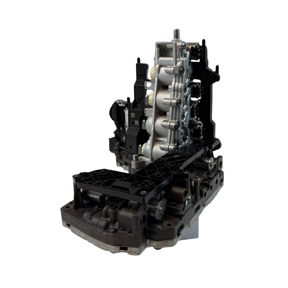 Side profile of a 0B5 DL501 mechatronic unit photographed on a clean workshop surface